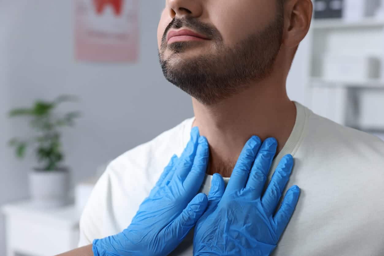 The doctor touching the patient's neck